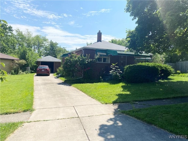 view of front of home featuring driveway, a chimney, a front lawn, and brick siding