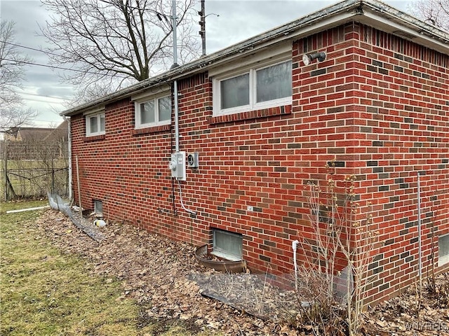 view of side of home featuring brick siding