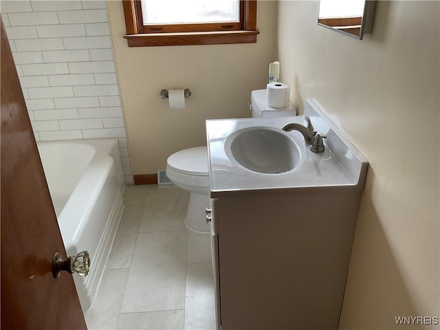 bathroom with toilet, a tub, vanity, and tile patterned floors