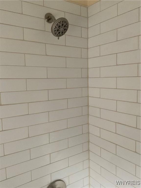 bathroom with a tile shower