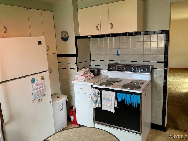 kitchen with white appliances, light countertops, and tile walls