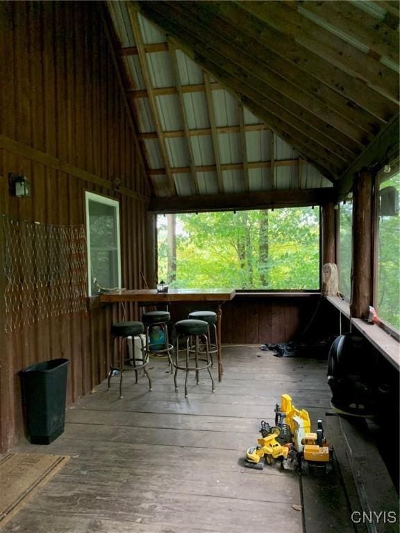 unfurnished sunroom with vaulted ceiling