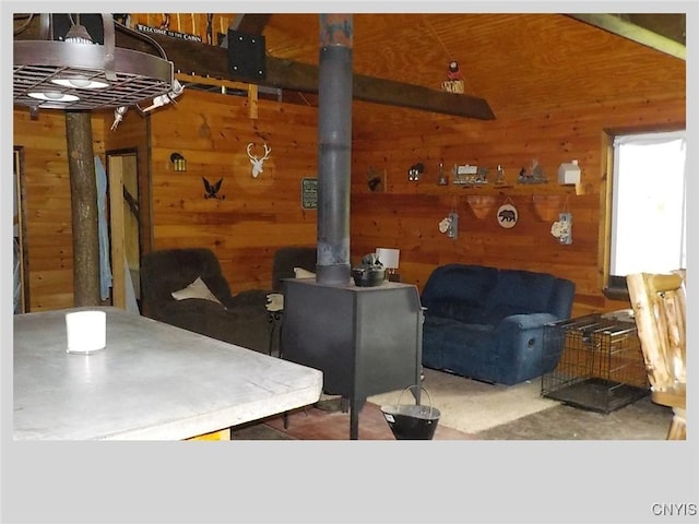 interior space with a wood stove and wooden walls