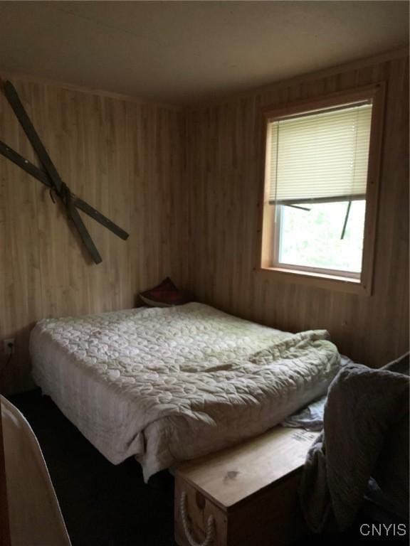 bedroom with wood walls