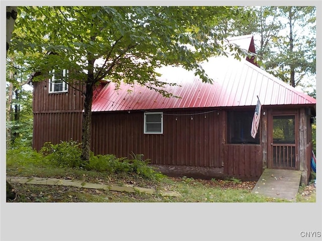 view of property exterior featuring metal roof