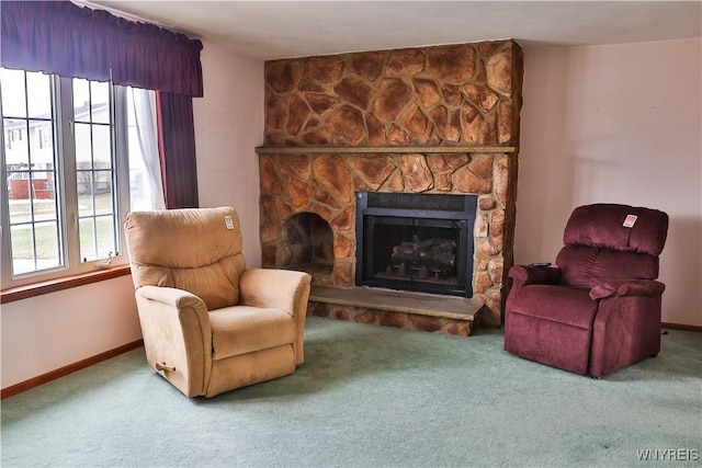 sitting room with plenty of natural light, carpet flooring, a fireplace, and baseboards