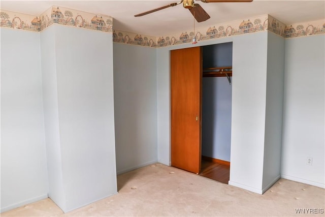 unfurnished bedroom featuring carpet floors, a closet, ceiling fan, and baseboards