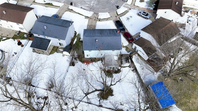 snowy aerial view with a residential view