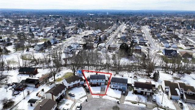 snowy aerial view with a residential view