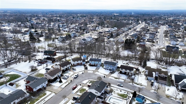 snowy aerial view featuring a residential view