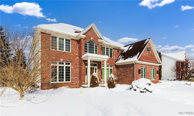 traditional home featuring brick siding