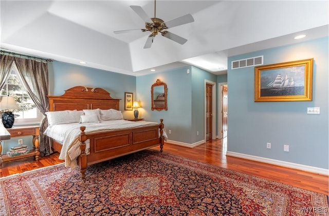 bedroom featuring recessed lighting, wood finished floors, visible vents, and baseboards