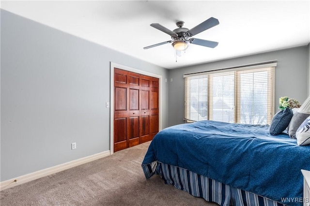 bedroom featuring carpet floors, a closet, ceiling fan, and baseboards