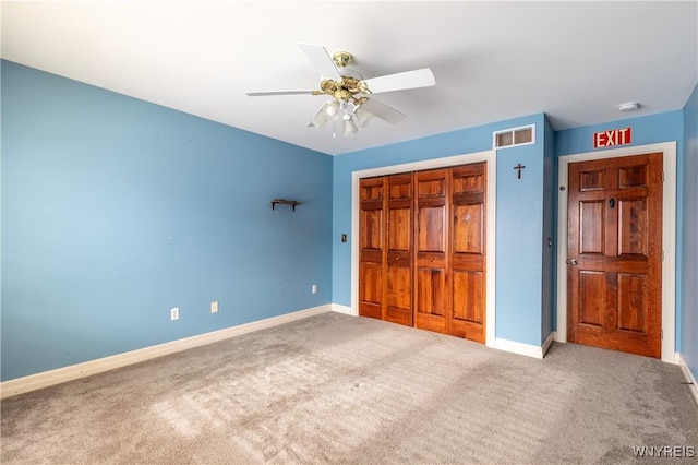 unfurnished bedroom featuring carpet floors, a closet, and baseboards