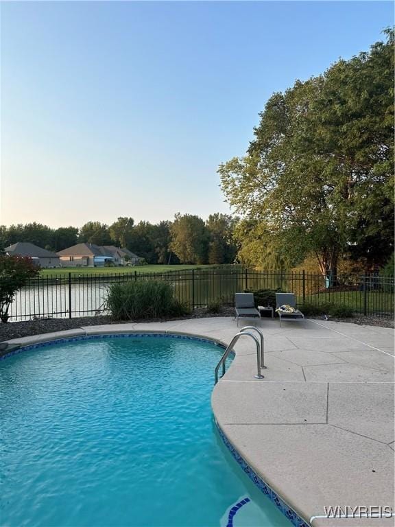 view of swimming pool featuring a patio area, fence, and a fenced in pool