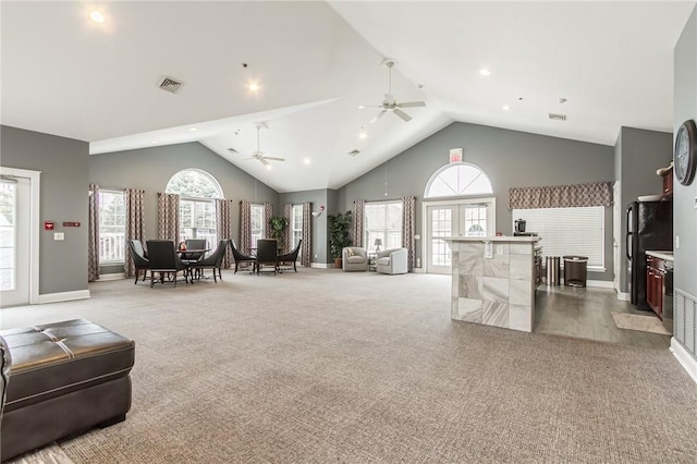 living room with plenty of natural light, visible vents, and carpet flooring