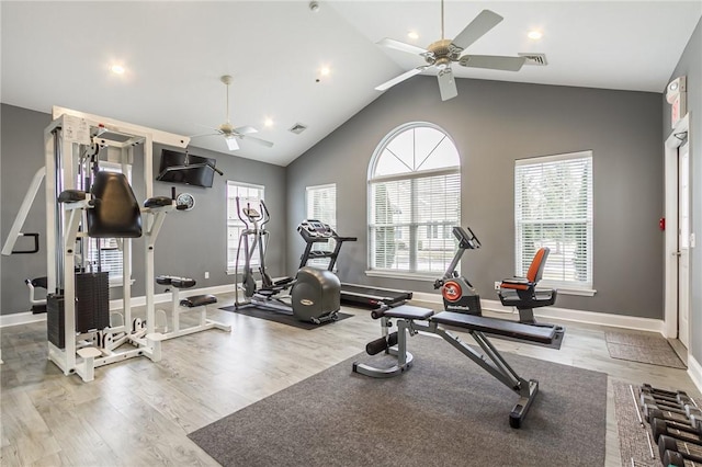 workout area with baseboards, visible vents, and wood finished floors