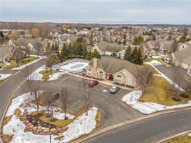 snowy aerial view featuring a residential view