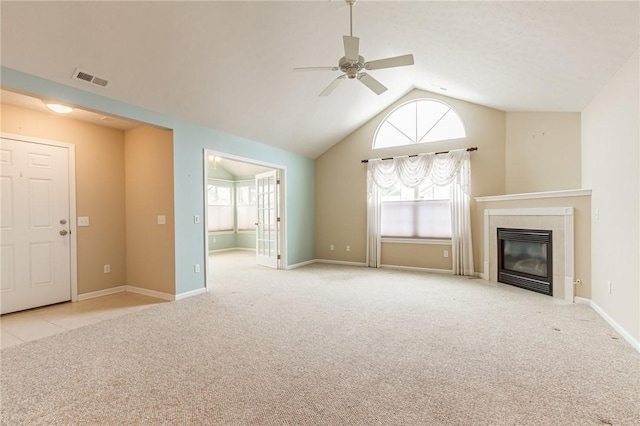 unfurnished living room featuring carpet floors, a fireplace, visible vents, a ceiling fan, and vaulted ceiling