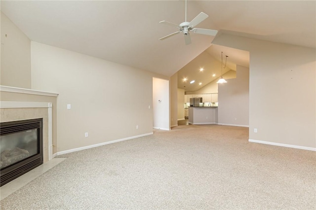 unfurnished living room featuring light colored carpet, a tiled fireplace, a ceiling fan, high vaulted ceiling, and baseboards