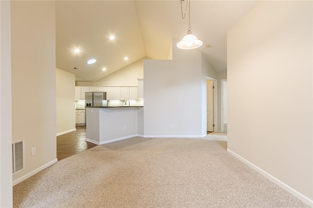 unfurnished living room featuring baseboards, visible vents, carpet flooring, high vaulted ceiling, and recessed lighting