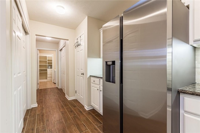 corridor featuring baseboards and wood finish floors