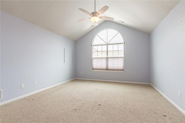 carpeted spare room featuring lofted ceiling, ceiling fan, visible vents, and baseboards