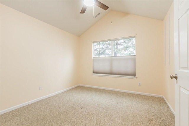 carpeted empty room with lofted ceiling, visible vents, ceiling fan, and baseboards