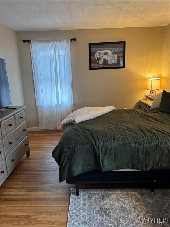 bedroom featuring wood finished floors