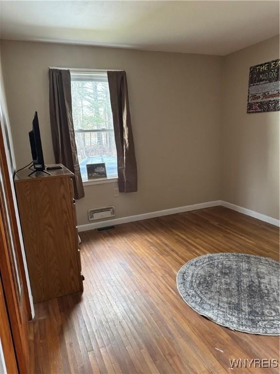 interior space with hardwood / wood-style flooring and baseboards