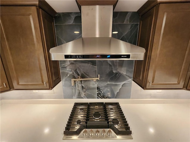 room details with tasteful backsplash and wall chimney range hood