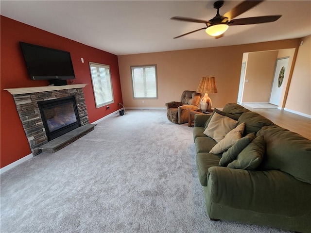 living area featuring carpet flooring, a fireplace, and baseboards