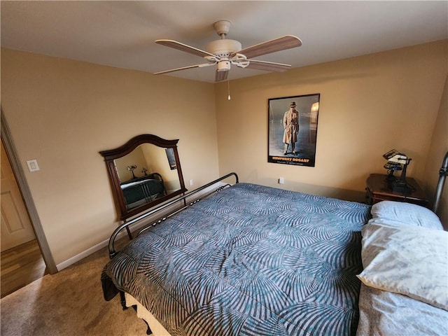 carpeted bedroom featuring a ceiling fan and baseboards