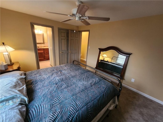 carpeted bedroom featuring connected bathroom, baseboards, and ceiling fan