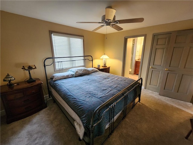 bedroom featuring a ceiling fan, connected bathroom, and light colored carpet