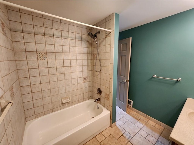 bathroom with visible vents, vanity, baseboards, and bathing tub / shower combination