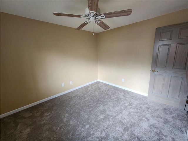 spare room with carpet, ceiling fan, and baseboards