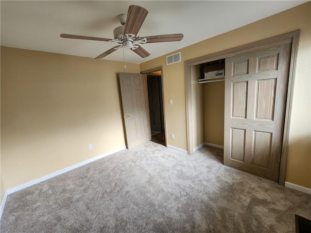 unfurnished bedroom featuring carpet floors, a closet, visible vents, and baseboards