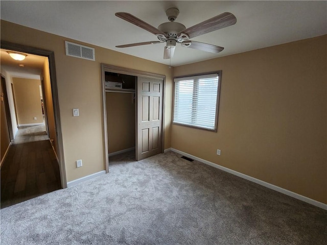 unfurnished bedroom featuring a closet, carpet, visible vents, and baseboards