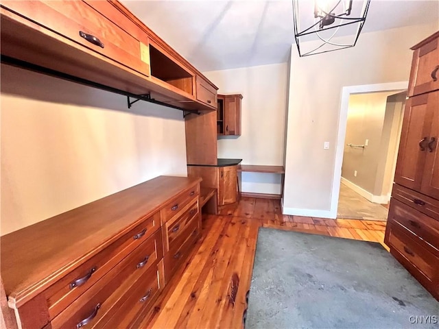 walk in closet featuring light wood finished floors