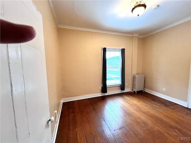 unfurnished room featuring radiator, crown molding, baseboards, and hardwood / wood-style flooring