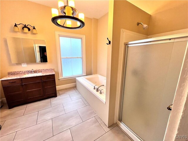 bathroom featuring a stall shower, tile patterned floors, a bath, and vanity