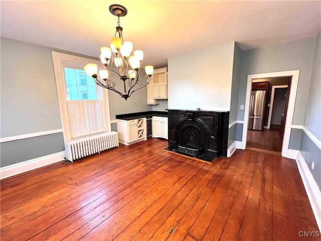 interior space with baseboards, dark wood-type flooring, wine cooler, and radiator