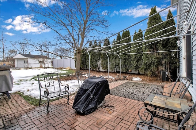 view of patio with grilling area and fence