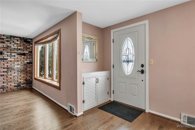 entrance foyer featuring wood finished floors, visible vents, and baseboards