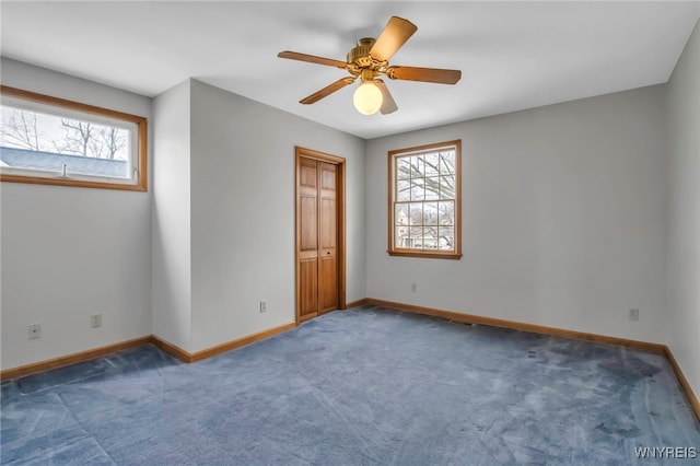 unfurnished bedroom featuring carpet flooring, ceiling fan, and baseboards