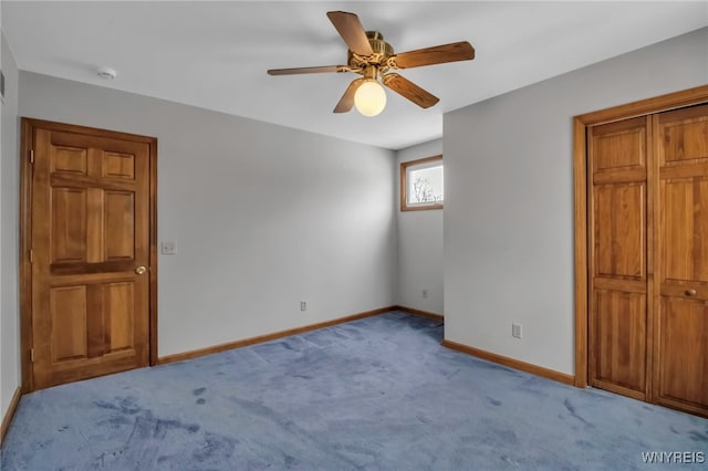 unfurnished bedroom featuring ceiling fan, baseboards, and light colored carpet