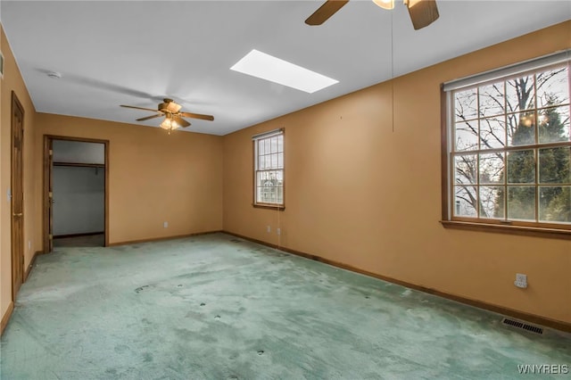 unfurnished bedroom with baseboards, visible vents, a ceiling fan, carpet flooring, and a closet