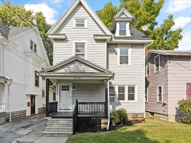 view of front of house with a porch and a front lawn