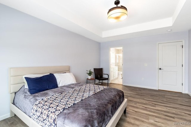 12 Kevwood Ln, Lancaster, NY 14086 - bedroom with baseboards, a tray ceiling, and wood finished floors